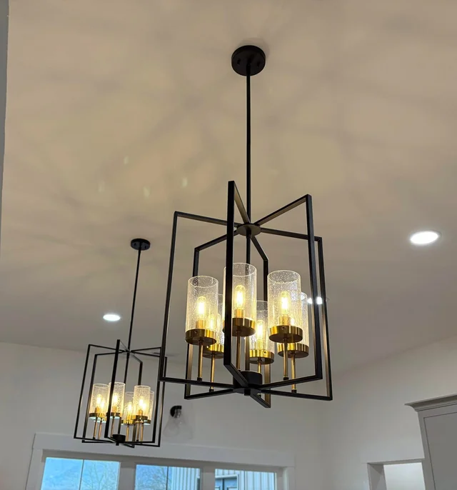 Two black framed pendant lights and recessed ceiling lights in a home